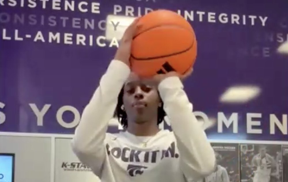 Live call with a Kansas State player: her set point paused on screen in the Kansas State practice facility