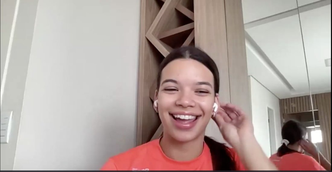 A college player on a live call, laughing